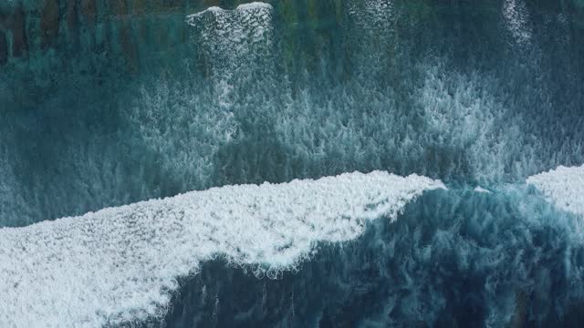 Slow motion top view of sea foamy bewitchingly splashing waves