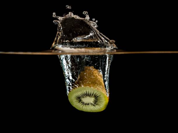Kiwi Fruit Falling Into Water