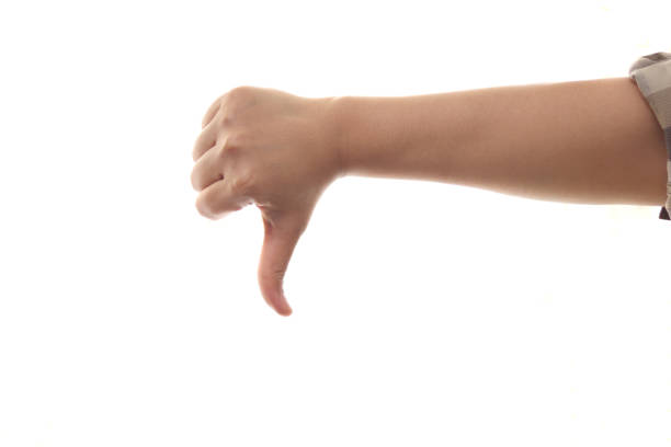 istock Hand of a person shows thumb down gesture, side view, isolated cut out on white 1307490144