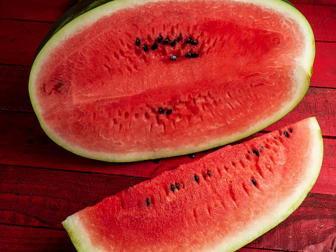 Red and juicy watermelon on wooden table.