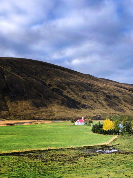 istock Svinavatn, Iceland: Red and White Church and Mountain 1307490924