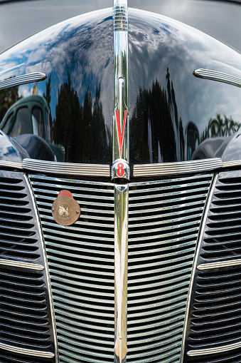 Miami, Florida USA - March 12, 2017: Close up view of the front of a beautifully restored vintage 1940 Ford Tudor automobile at a public car show along Palmetto Bay.