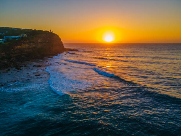 istock Aerial sunrise seascape with hazy blue sky 1307500083
