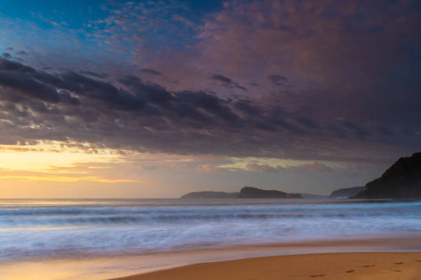 istock Sunrise seascape at the beach with haze and cloud 1307500630