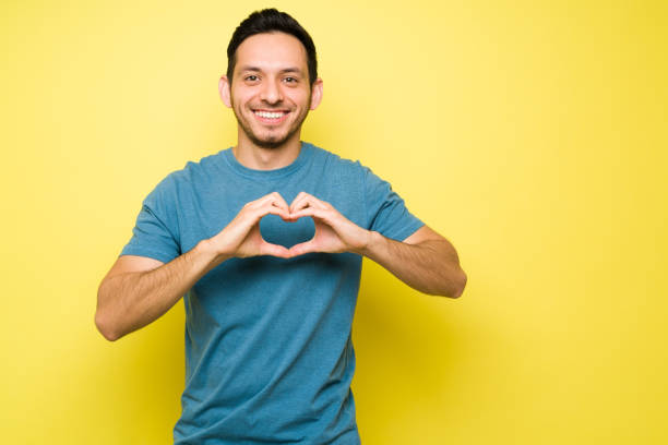 istock Cheerful hispanic man offering his love to someone 1307503661