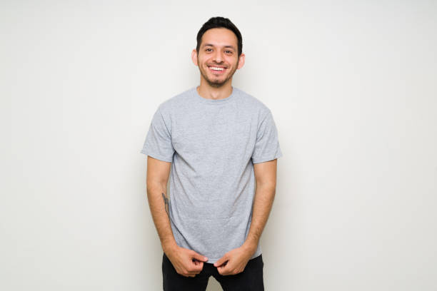 istock Good-looking hispanic man with a mock up gray t-shirt 1307504244