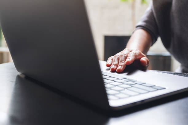 istock a woman working and touching on laptop touchpad on the table 1307506869