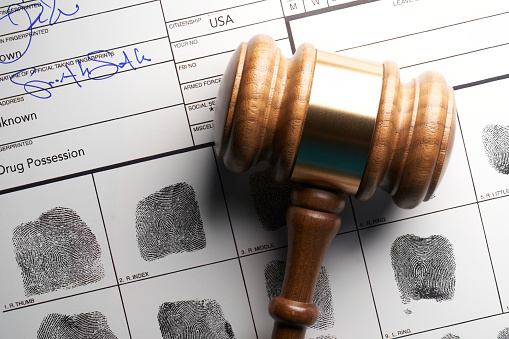 Gavel on fingerprint document from getting arrested