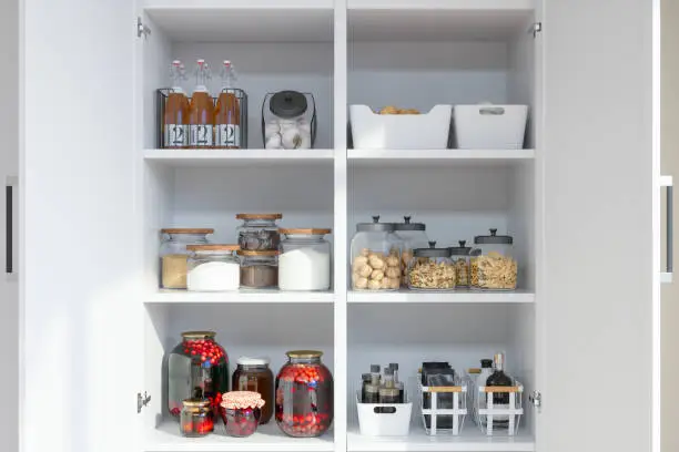 Photo of Organised Pantry Items With Variety of Nonperishable Food Staples And Preserved Foods in Jars On Kitchen Shelf.