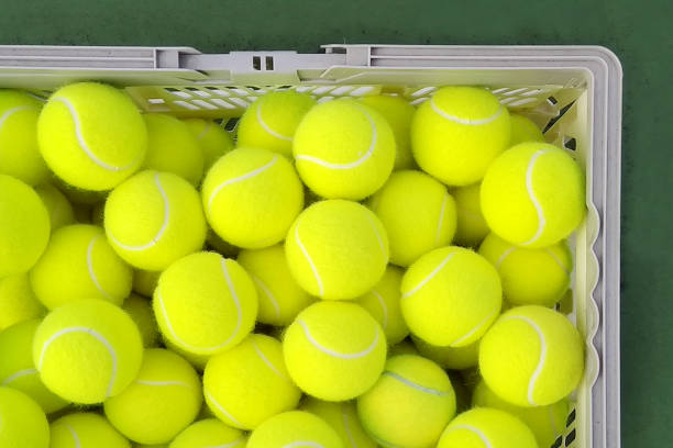 istock Tennis balls in basket 1307510371