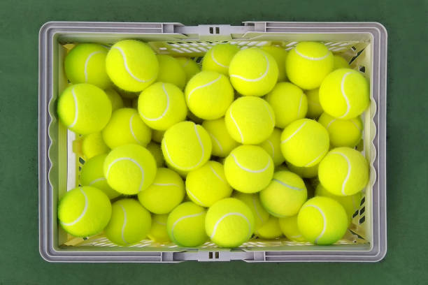 istock Tennis balls in basket 1307510379