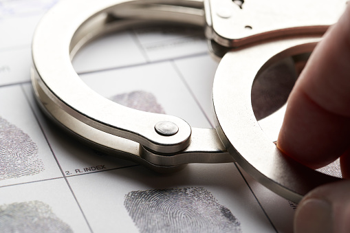 Handcuffs on fingerprint document from getting arrested