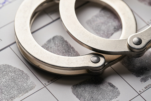 Handcuffs on fingerprint document from getting arrested