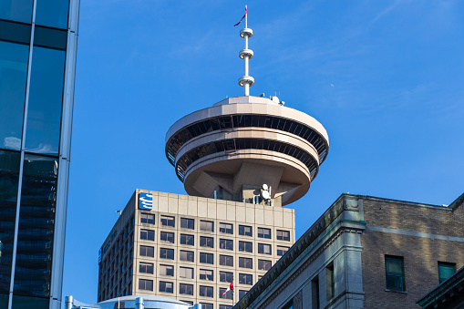 Famous Harbour Centre and Vancouver Lookout seen from street level in downtown Vancouver, BC on clear spring day.