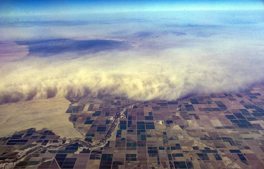 Aerial view of dust storm overrunning the Imperial Valley, California, USA. Salton Sea in upper left. Scanned film with significant grain, September 1965.
