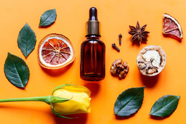 istock perfume and ingredients on orange background close up 1307515302