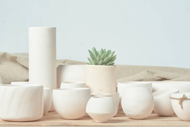 istock Unglazed white clay pots on wood table 1307515521