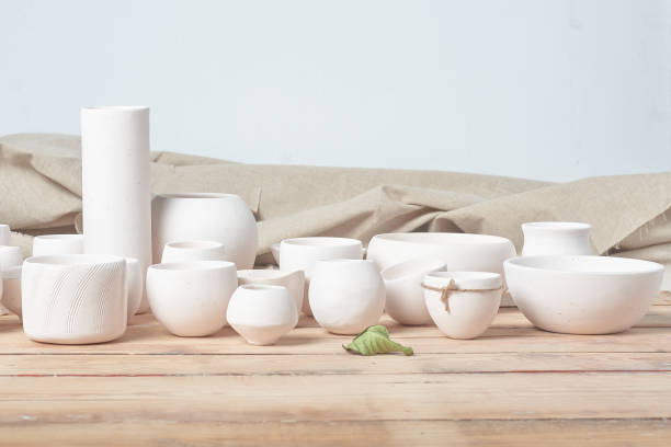 istock Unglazed white clay pots on wood table 1307515548