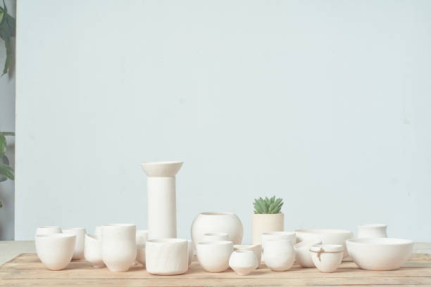istock Unglazed white clay pots on wood table 1307515644