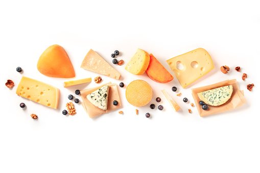 Cheese. Many different types of cheeses, overhead flat lay shot on a white background with copy space