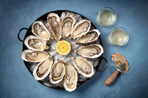 istock Oysters with white wine and a shucking knife 1307516367