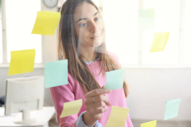 istock Business woman looking at sticky notes 1307517912
