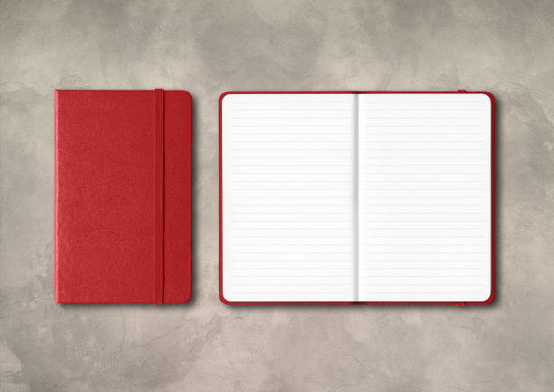 istock Dark red closed and open lined notebooks on concrete background 1307519808