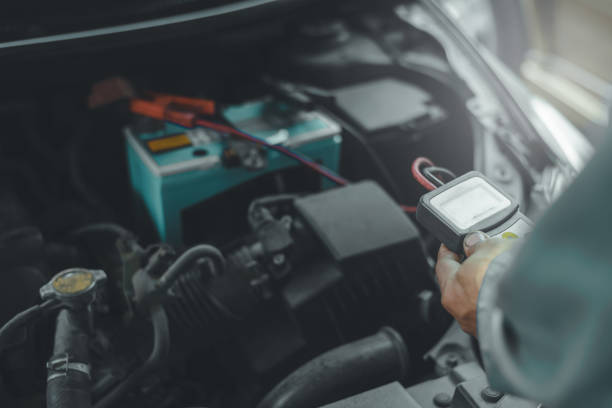 istock Selective focus an auto mechanic uses a multimeter voltmeter to check the voltage level in a car battery. 1307519848