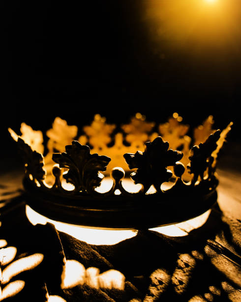 istock The crown looks expensive on a black background illuminated by a golden beam. Low-key image of a king of the crown . Fantasy of the medieval period. Battle for the Throne. 1307519955