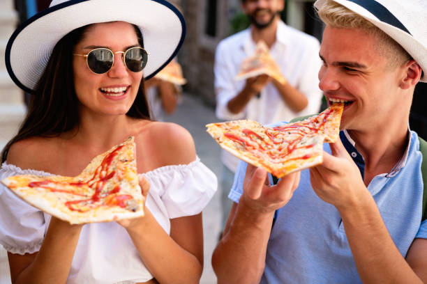 istock Couple eating pizza while traveling on vacation 1307520653