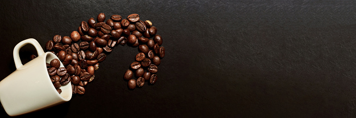 Coffee header with a coffee grain scattered from the white mug. Food and drinks backgrounds