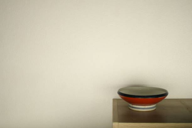 istock red white ceramic bowl on white wall beautiful background 1307520871
