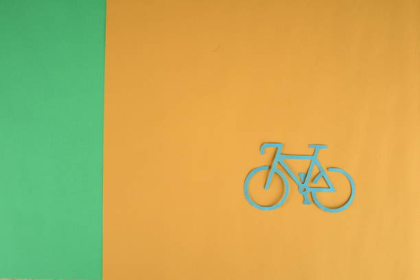 istock yellow bicycle with space on green and orange background 1307521540