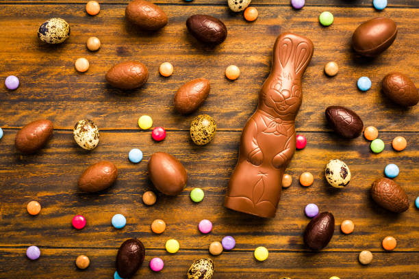 istock Chocolate Easter bunny with sweet chocolate eggs and colorful sweets 1307526609