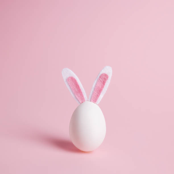 istock Easter egg with bunny ears on pastel pink background 1307526668