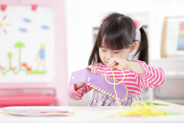 Young Girl Sweing Pad Craft Using Plastic Needle And Yarn For Homeschooling