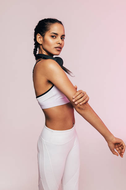istock Side view of a young mixed race woman warming up her arm before exercises 1307529257