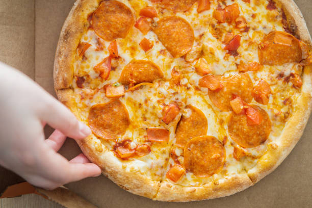 istock Pizza Pepperoni in a carton box. view from above 1307530383