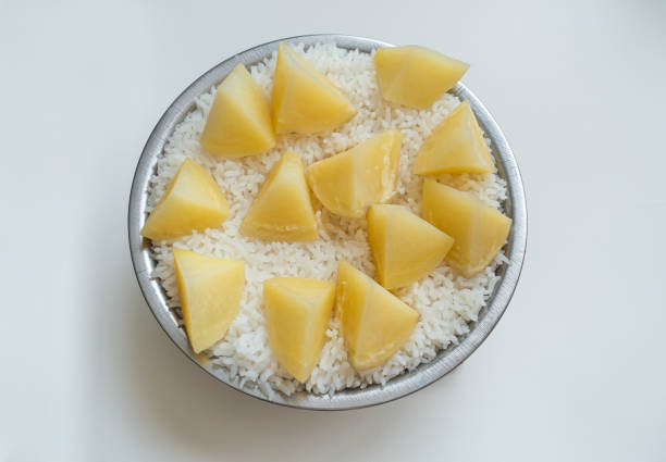 Potatoes and rice are steamed in a pot
