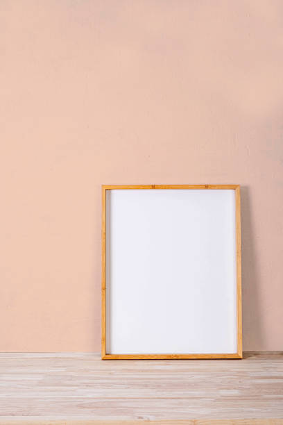 istock vertical wood frame mock up on wooden floor and Light brown background 1307533331