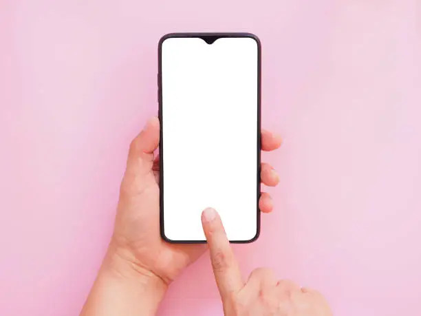 The hand-holding smartphone shows a white screen display on pink background. Top view, flat lay with copy space.