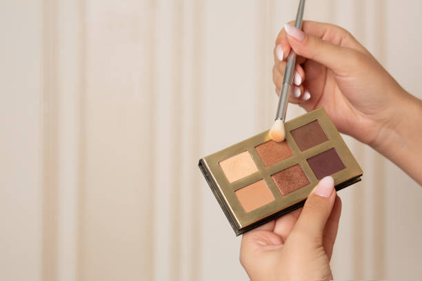 istock Beautician holding mini eye shadow palette 1307535850