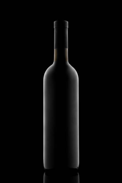 istock illuminated silhouette of a bottle with wine on a black background 1307535875