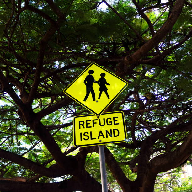 istock Bright yellow Refuge Island sign among trees 1307537040