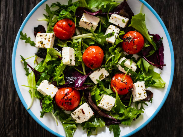 istock Greek salad on wooden table 1307537296