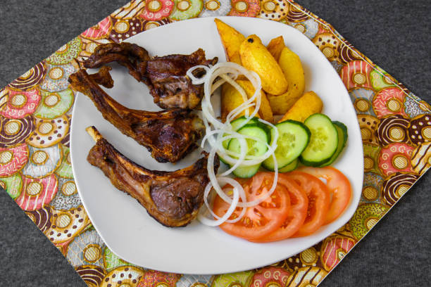 istock Fried lamb ribs with potatoes and vegetables. 1307539161