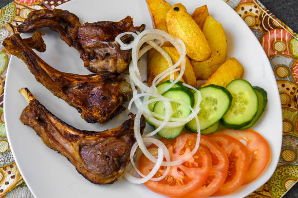 istock Fried lamb ribs with potatoes and vegetables. 1307539258