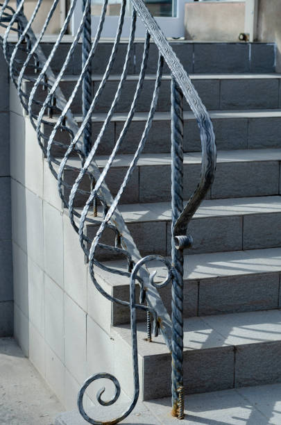 istock Gray stone staircase with wrought iron railings. 1307539556