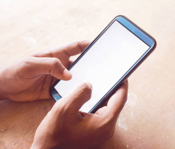 istock hand holding smart phone with white screen 1307539591