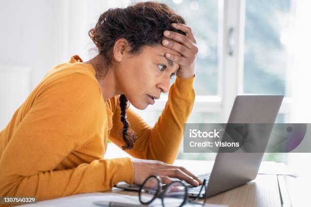 Young Woman Feeling Stressed While Looking Bank Account Online Stock Photo - Download Image Now